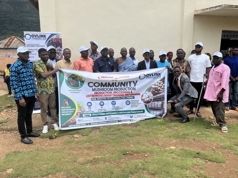 Wider view of the gathering assembled behind the launch banner outside the venue